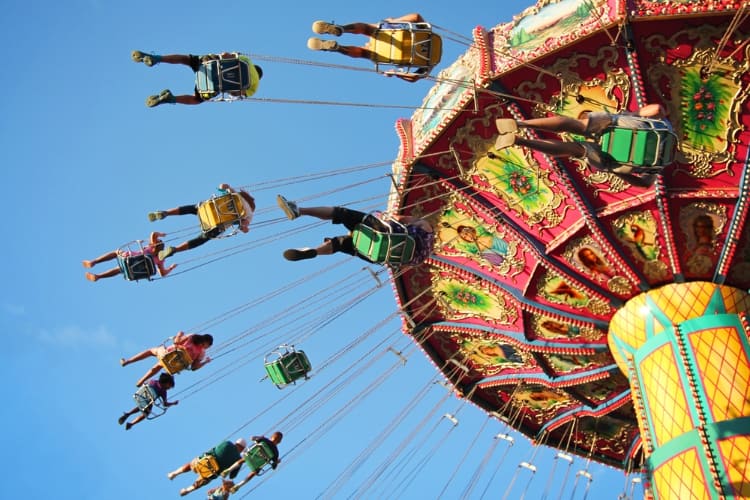 park visitors fly on a chairswing ride at Elitch Gardens