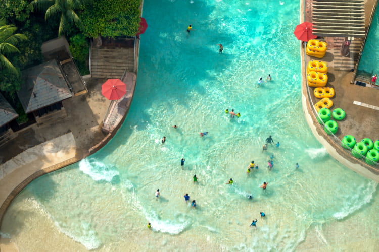 visitors enter a wave pool at Elitch Gardens