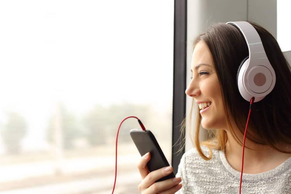 A young woman on a bus with headphones