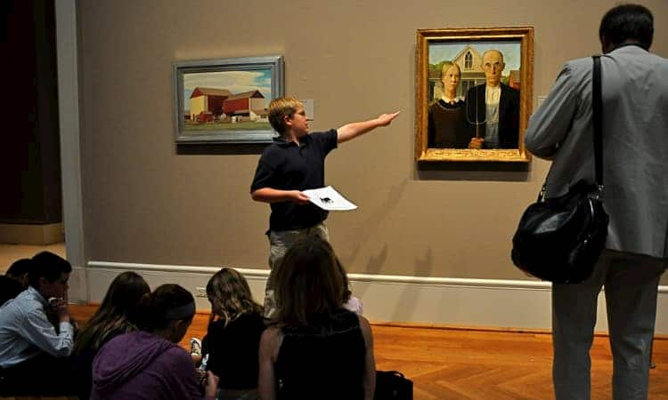 Student pointing at painting during presentation at Art Institute