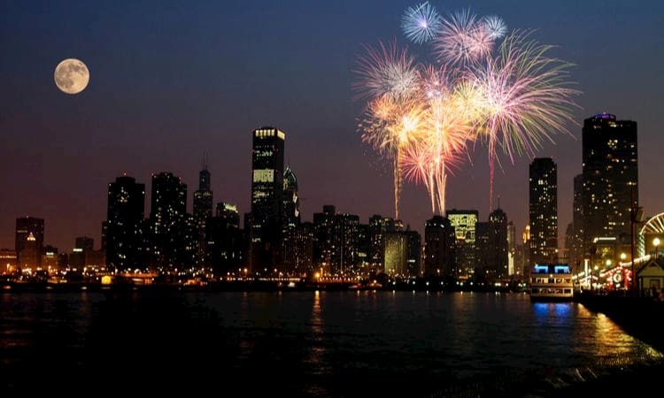 fireworks explode in the night sky over chicago