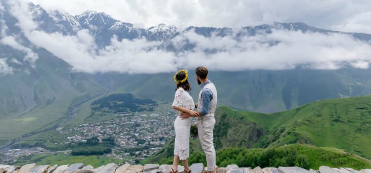 a bride and groom taking a photo in the foggy georgia mountains