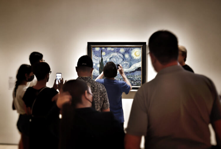 A group of guests looking at Picasso's Starry Night a the MoMA