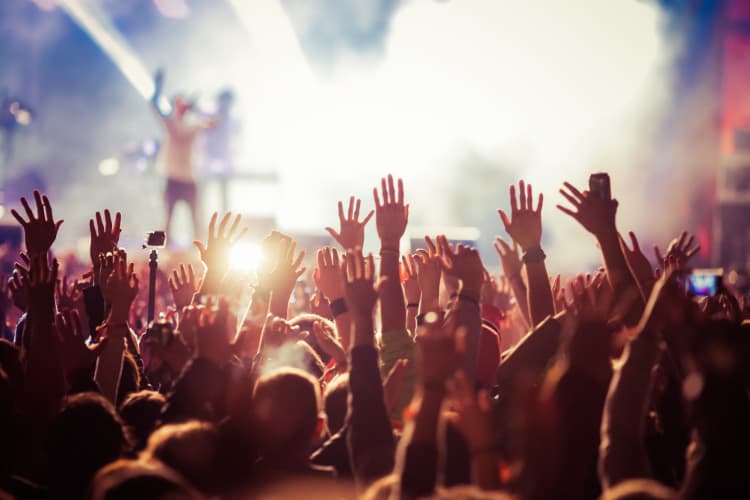 Hands waving in the audience at a concert