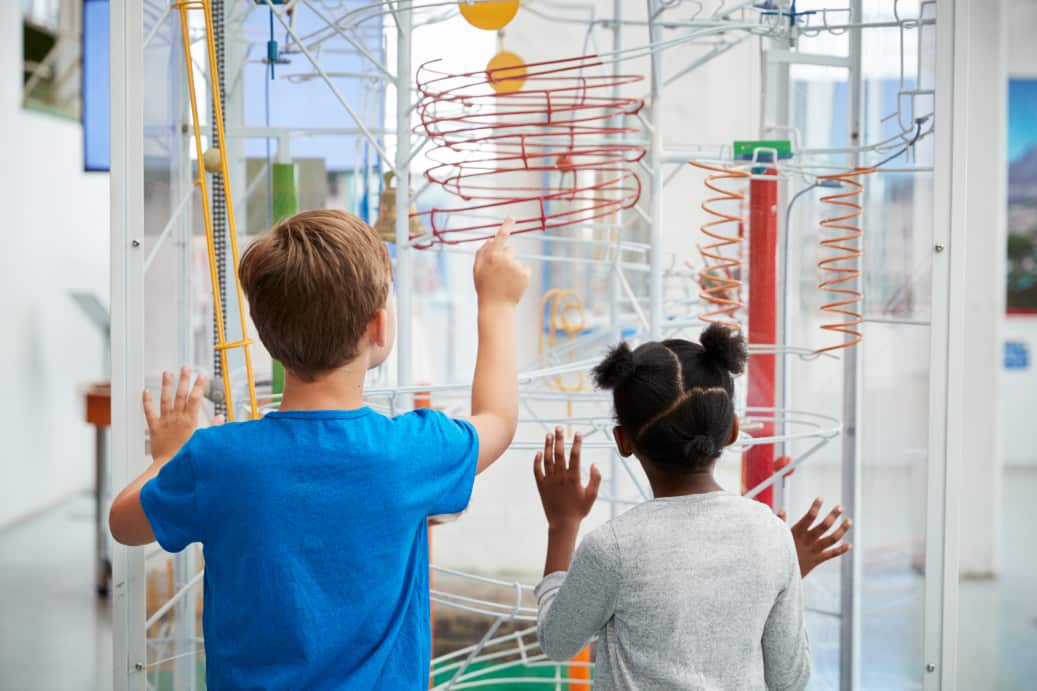 kids examine an exhibit at a san francisco museum