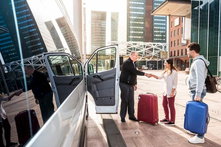 Couple getting picked up by charter bus at airport