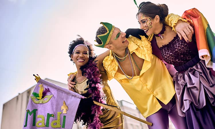 Party-goers walk in a Mardi Gras parade