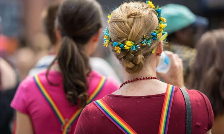 two women with rainbow suspenders at pride