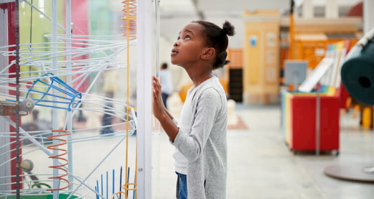 Little girl looking at science museum display