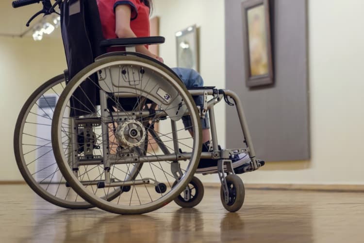 Person in wheelchair visiting art gallery