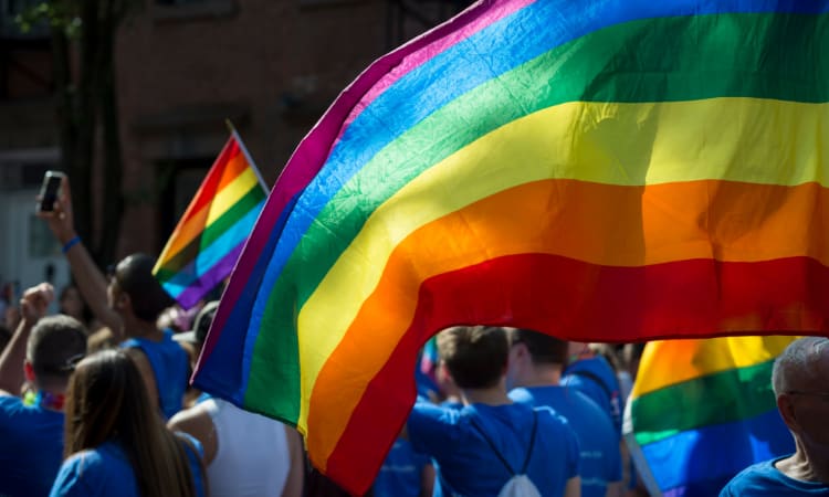 rainbow pride flags fly at a pride parade