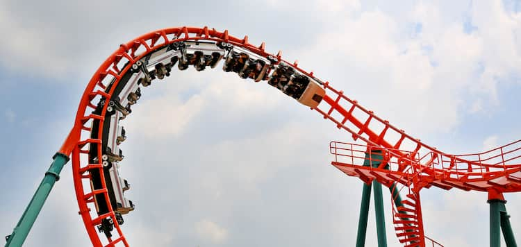 People riding roller coaster