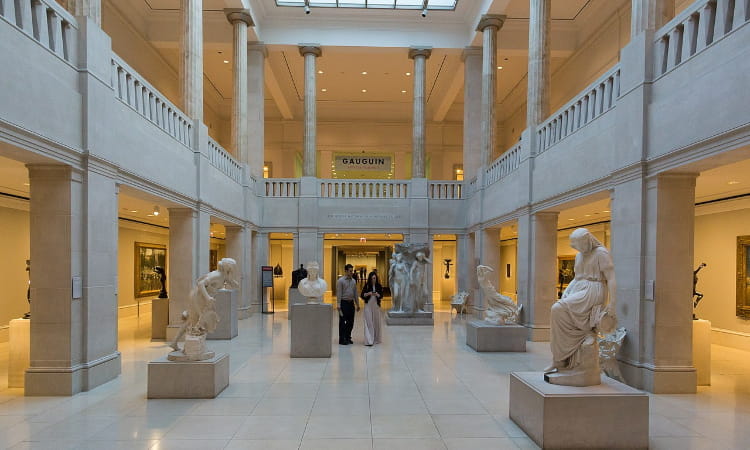 two visitors walk through a sculpture gallery at the art institute of chicago