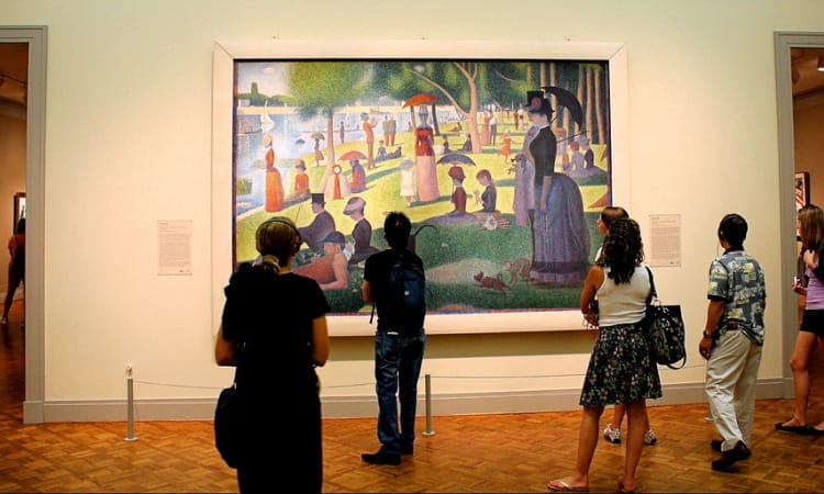 visitors gather to view a famous painting at the art institute