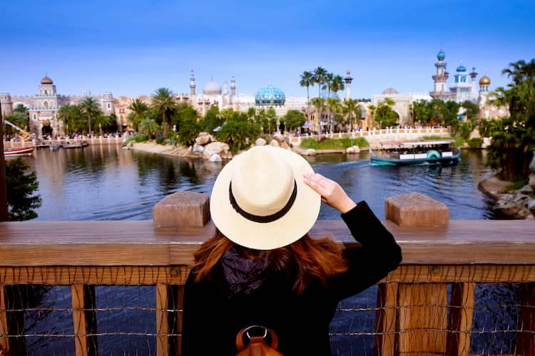 Tourist gazing across lake at Universal Orlando