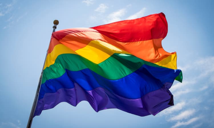 pride flag waving in the wind on a sunny day