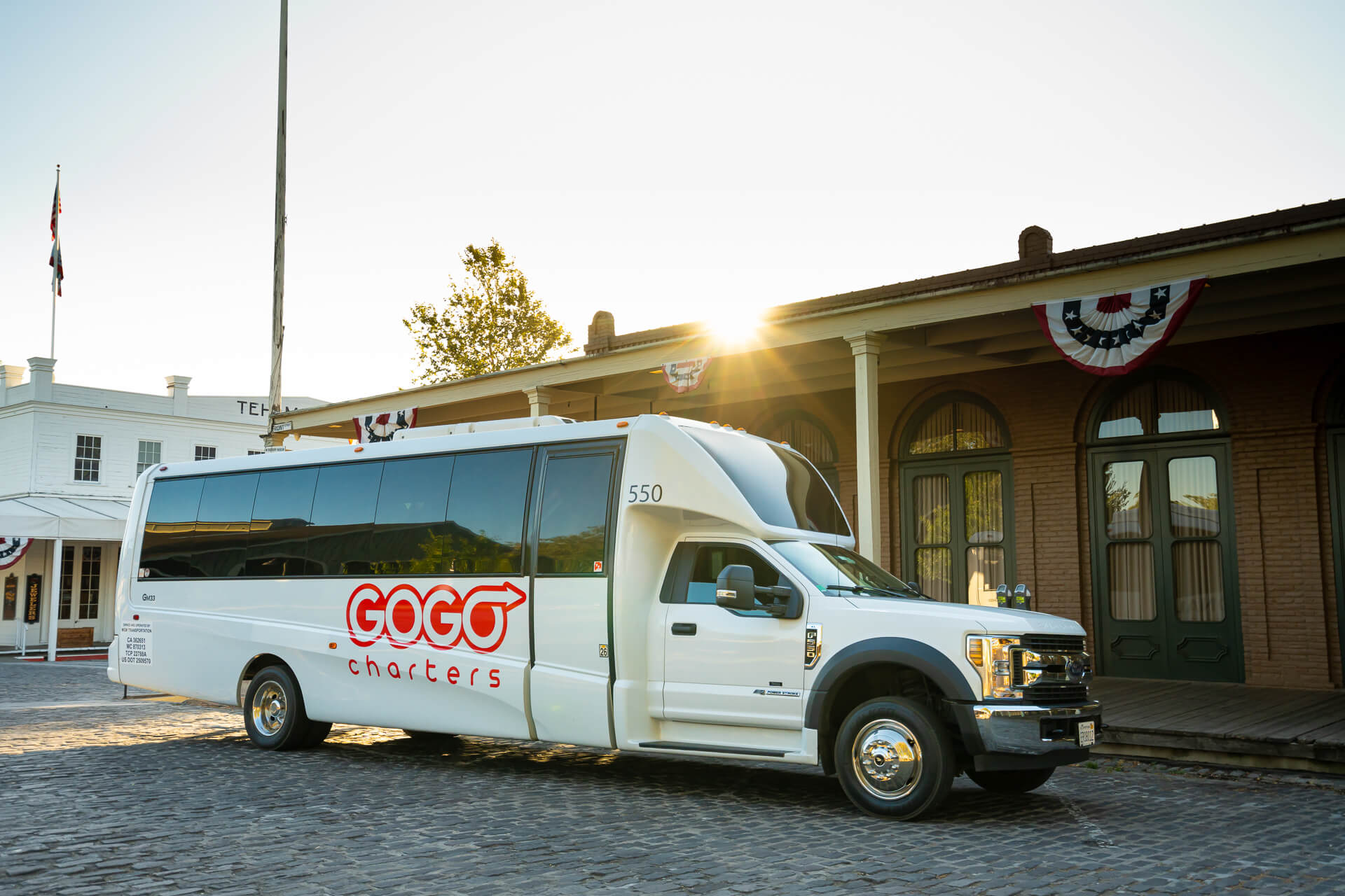 Minibus with GOGO charters logo on a cobblestone street