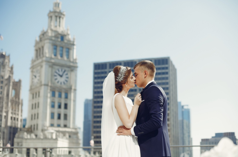two newlyweds share a kiss on an nyc rooftop