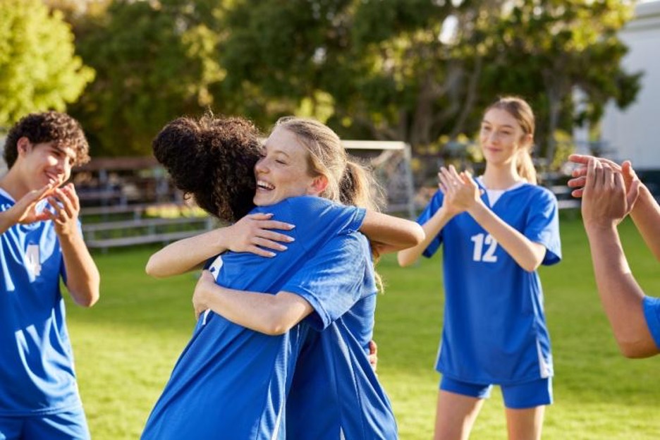 team members hug and cheer during a game