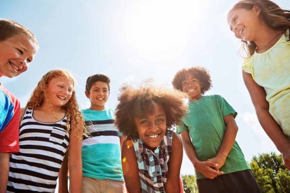 kids smile outside on a sunny day