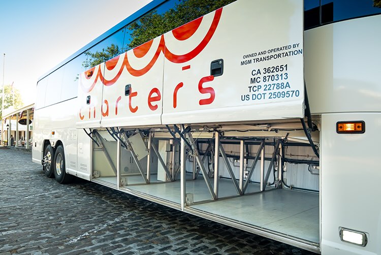 a gogo charter bus with the storage bay open