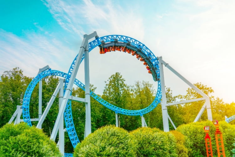 a wide shot of a blue rollercoaster