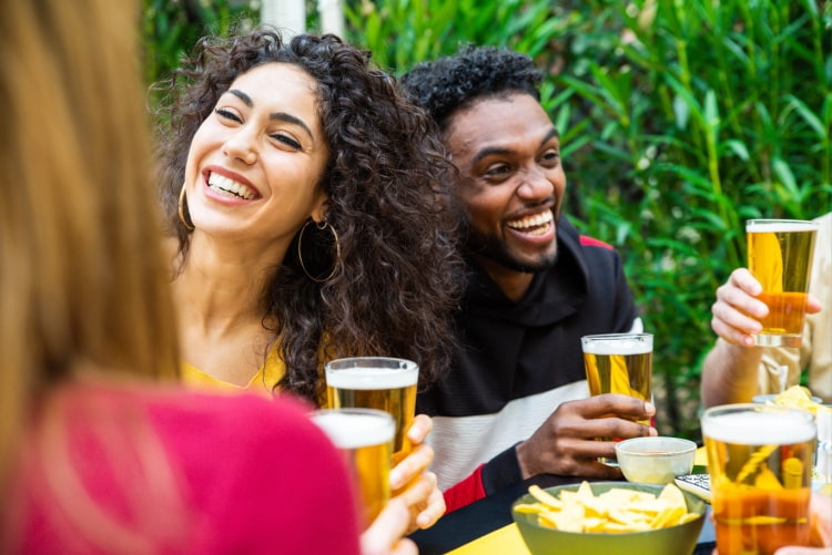 two friends laugh and enjoy a pint together
