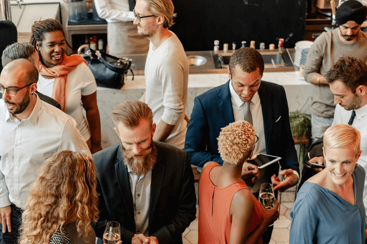 a group of corporate professionals mingle
