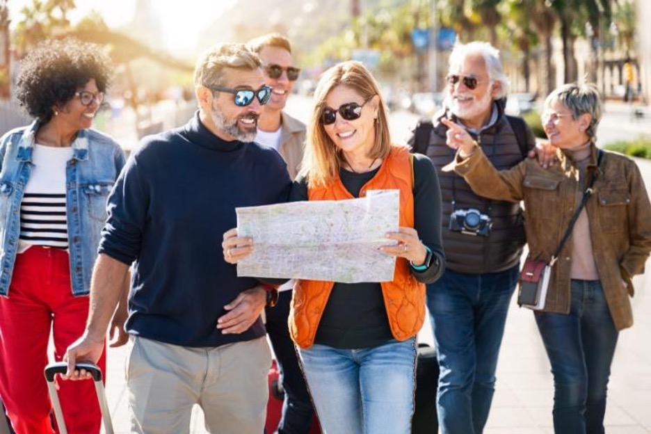 visitors look at a map of a city together