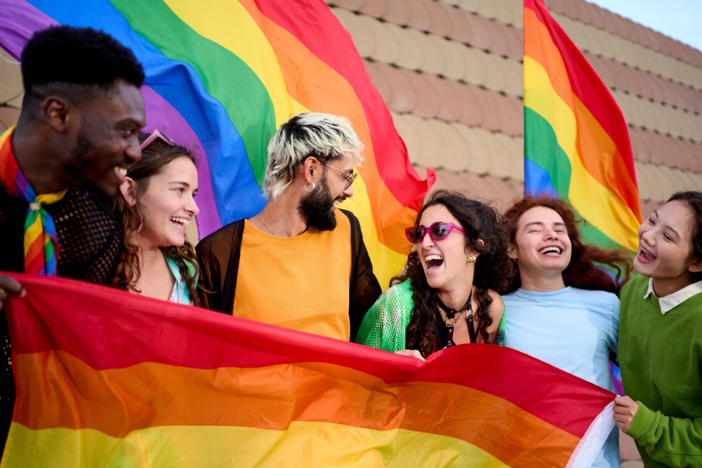 a group of friends hold up a rainbow flag at Chicago pride fest