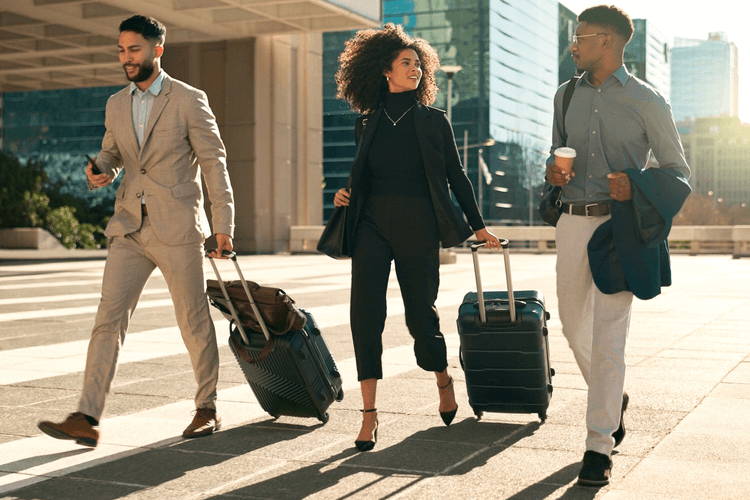 three travelers walking up to a hotel