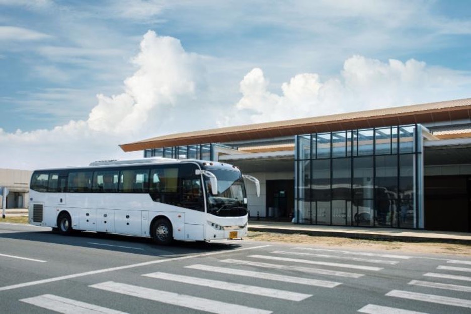 a charter bus pulls up to a terminal