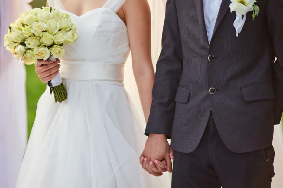 a couple holds hands after saying their vows