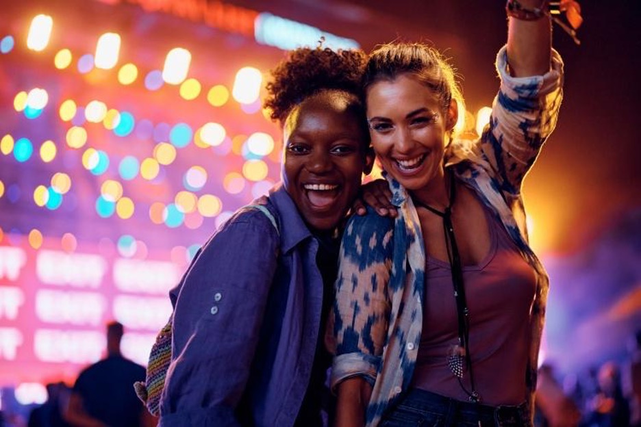 two friends cheer during a concert