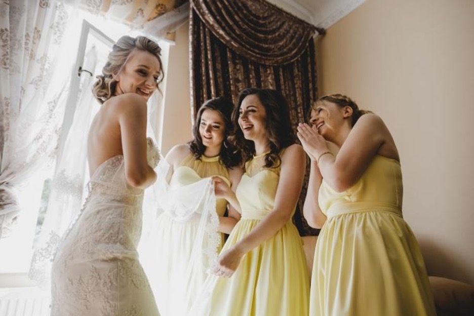 a bride and bridesmaids get ready for a wedding