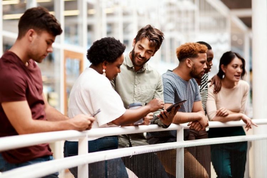employees review an event schedule at a large convention center