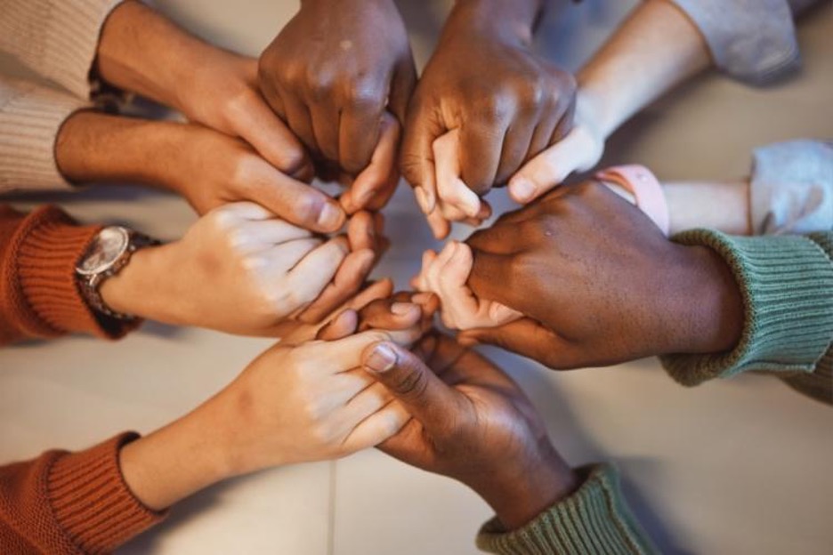 people join hands in a religious ceremony