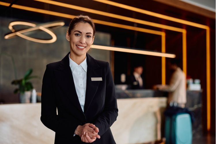 a hotel concierge smiling at a desk