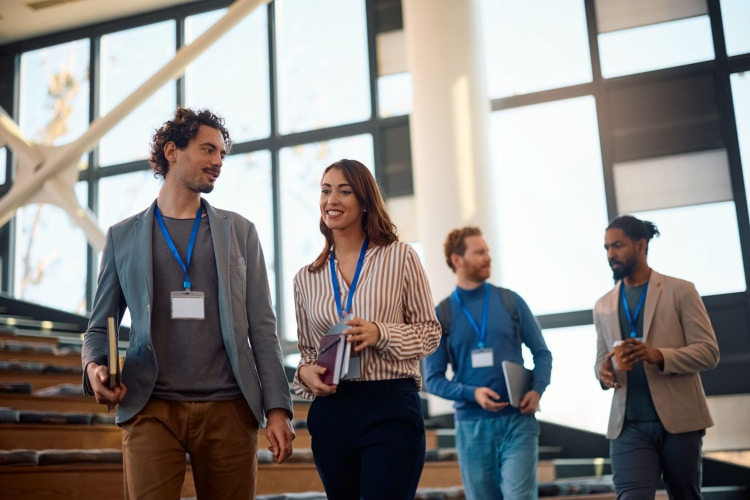 a group of coworkers walk through a convention center