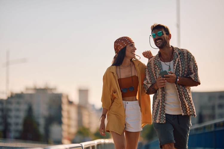 a couple walks outside together at sunset