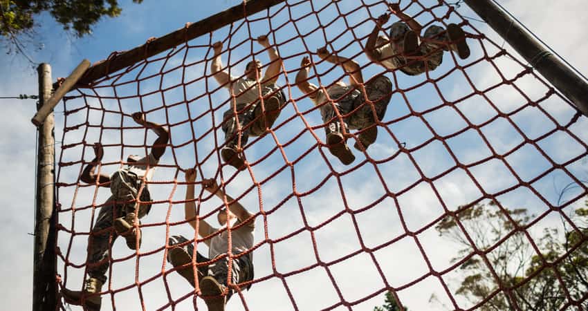 Soldiers training by climbing ropes