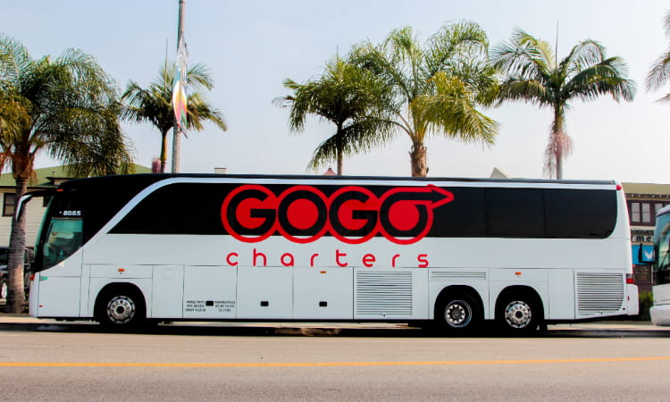 a GOGO Charters charter bus parks on a street in San Diego