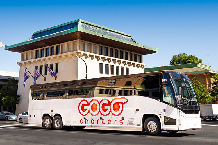 A full-size motorcoach traveling in the city.