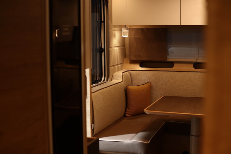 a small dining table nook in a band tour bus