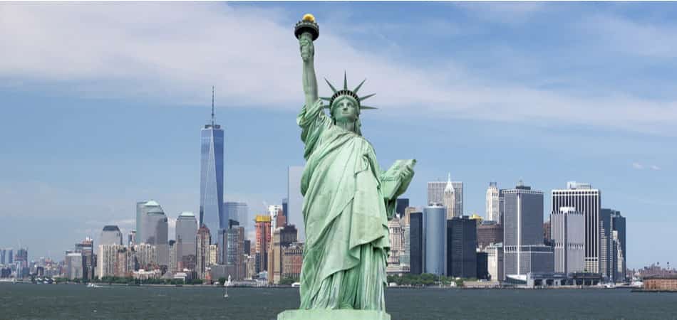 statue of liberty with manhattan in the background